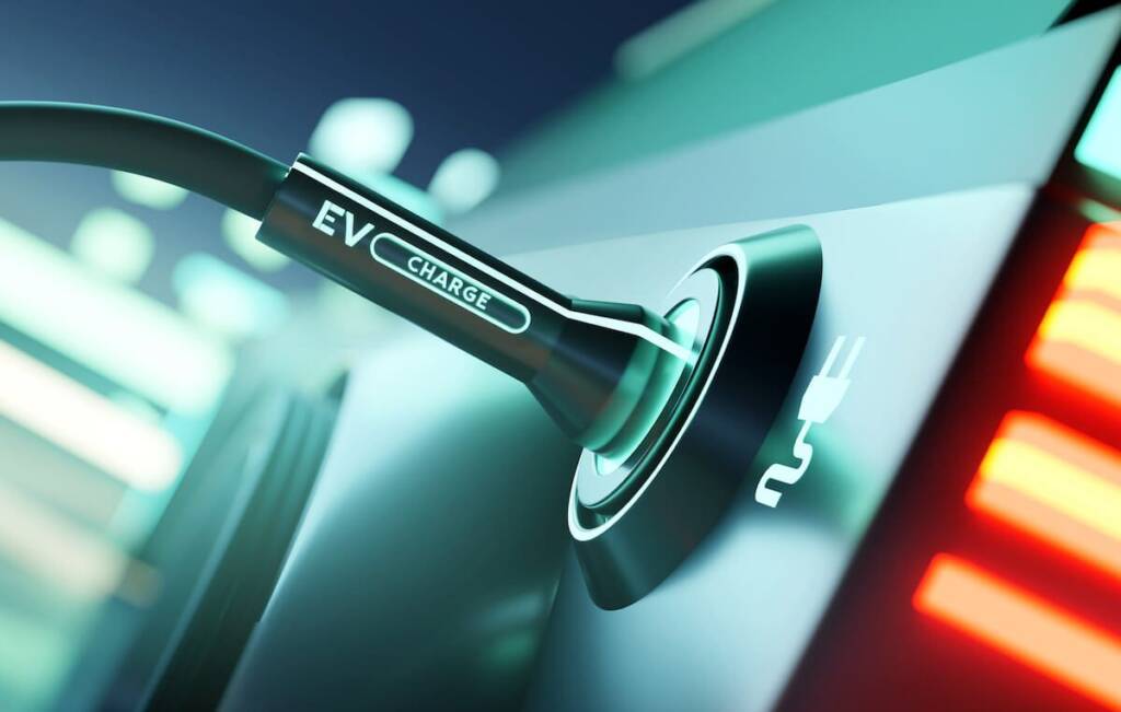 Close-up of an electric vehicle charging port with a connected cable showing "EV Charge.