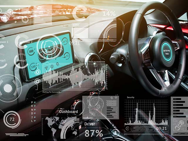 Futuristic car dashboard with digital displays, graphs, and data visualizations overlaying the steering wheel and controls.